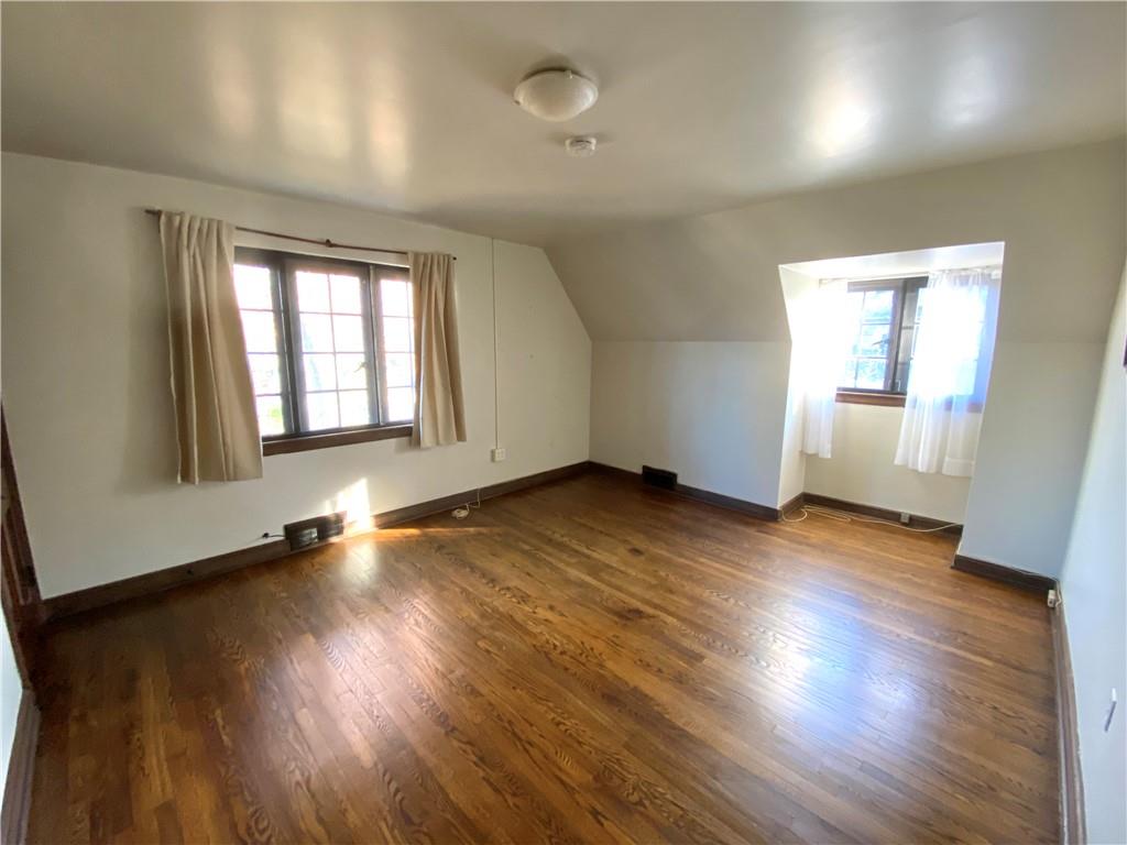 5659 Darlington Road Pittsburgh, PA 15217 - Photo 13 of 23 an empty room with wooden floor and windows