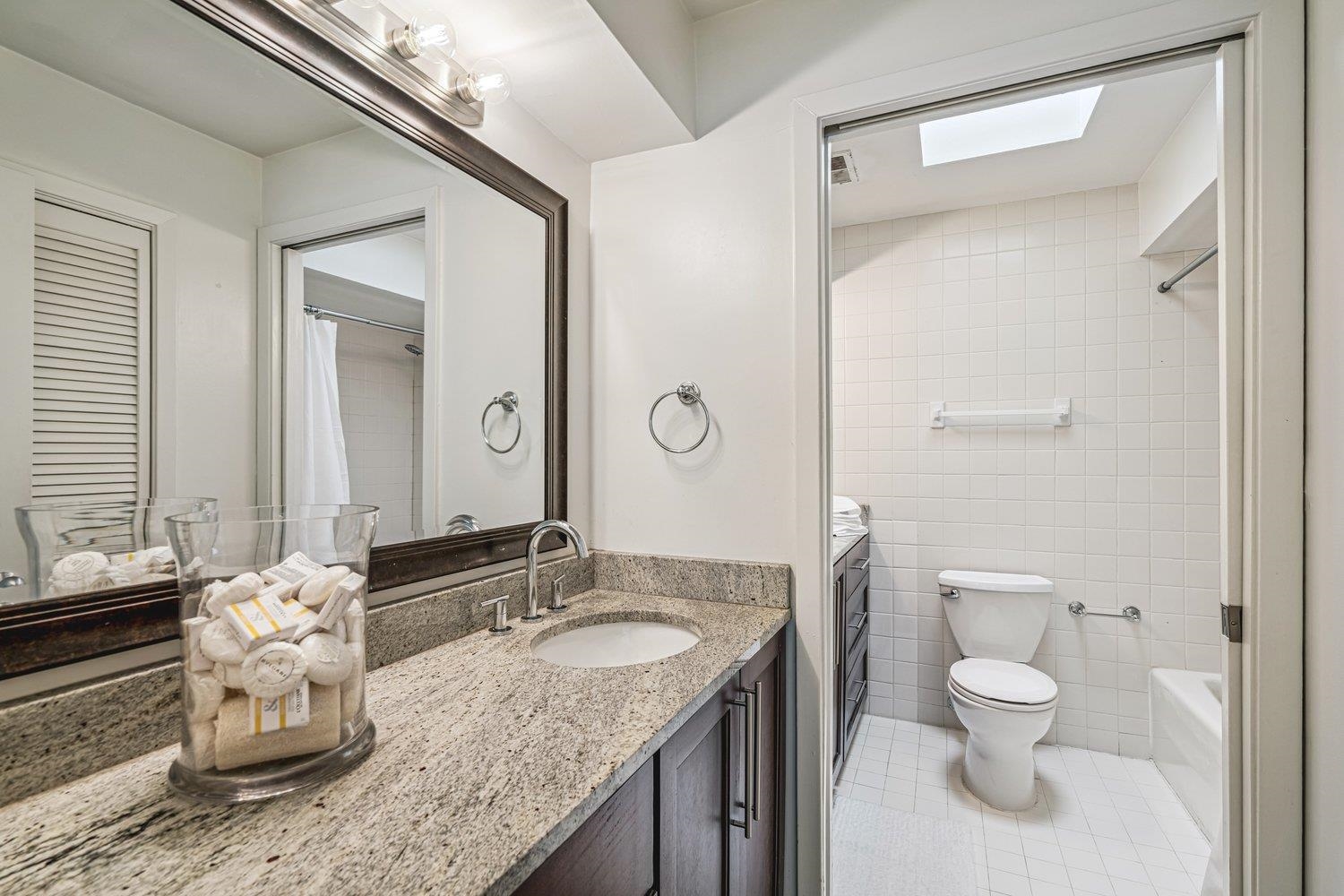 335 Riverbluff Place, Unit 3 Memphis, TN 38103 - Photo 12 of 17 a bathroom with a granite countertop sink toilet a mirror and shower