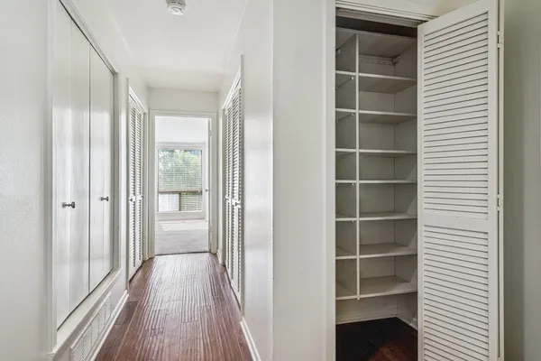 a view of walk in closet with empty room