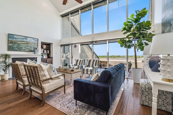 a living room with furniture a chandelier and a potted plant