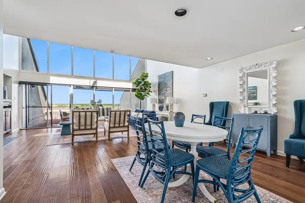 a view of a dining room with furniture and wooden floor