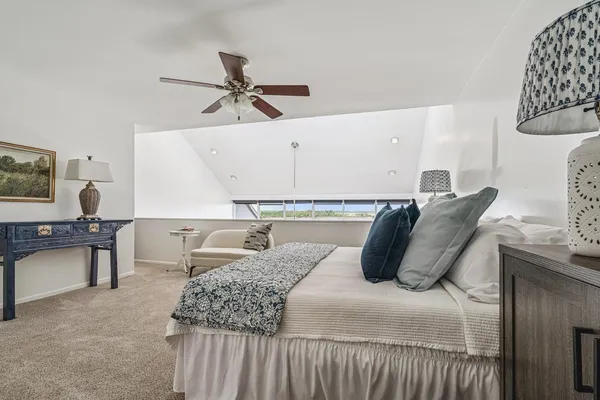 a bedroom with a bed and window