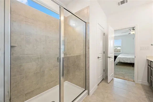 a en suite bathroom with double sink and a mirror