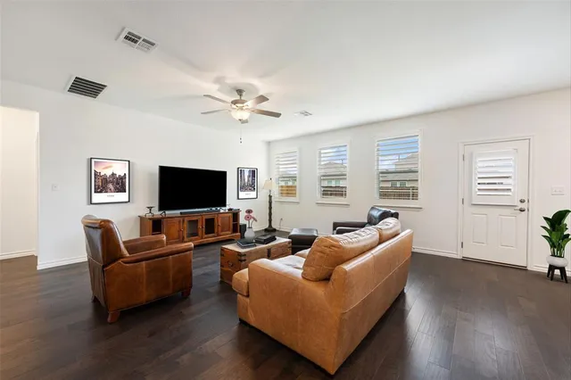 a living room with furniture kitchen view and a window