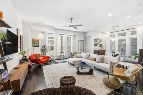 a kitchen with stainless steel appliances granite countertop a white cabinets and chairs