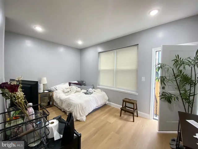 a bedroom with furniture and a potted plant