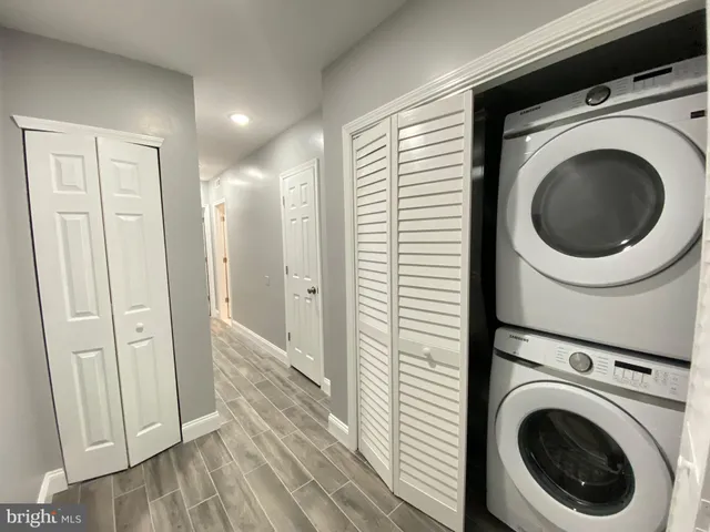 a view of a hallway with washer and dryer