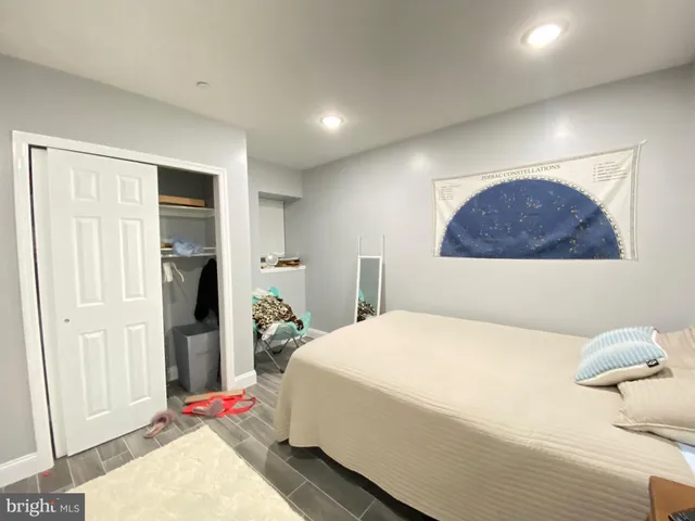 a bedroom with a bed and a dresser