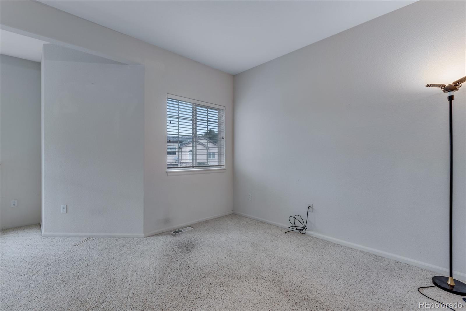 1405 South Chambers Road, Unit 103 Aurora, CO 80017 - Photo 12 of 20 a view of an empty room with a window