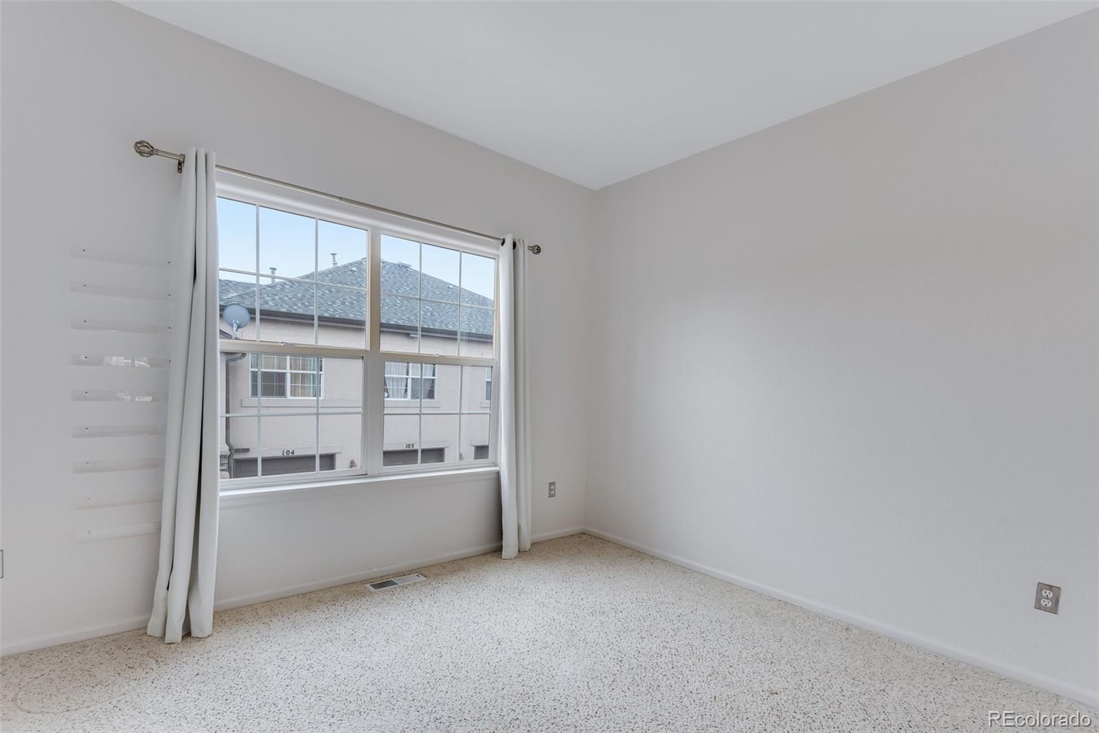 1405 South Chambers Road, Unit 103 Aurora, CO 80017 - Photo 15 of 20 a view of an empty room with a window