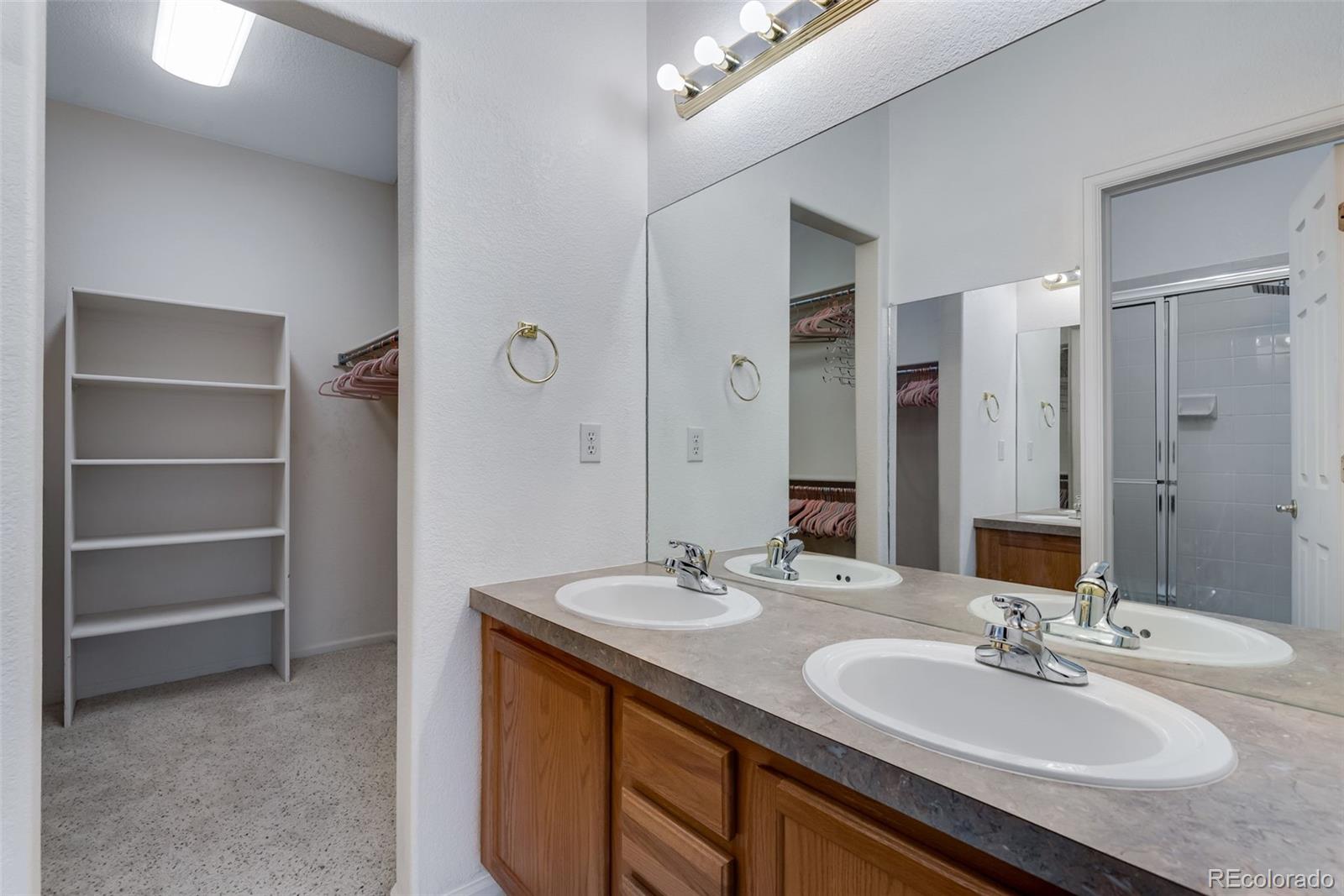 1405 South Chambers Road, Unit 103 Aurora, CO 80017 - Photo 20 of 20 a bathroom with a sink double vanity granite tub shower and a mirror