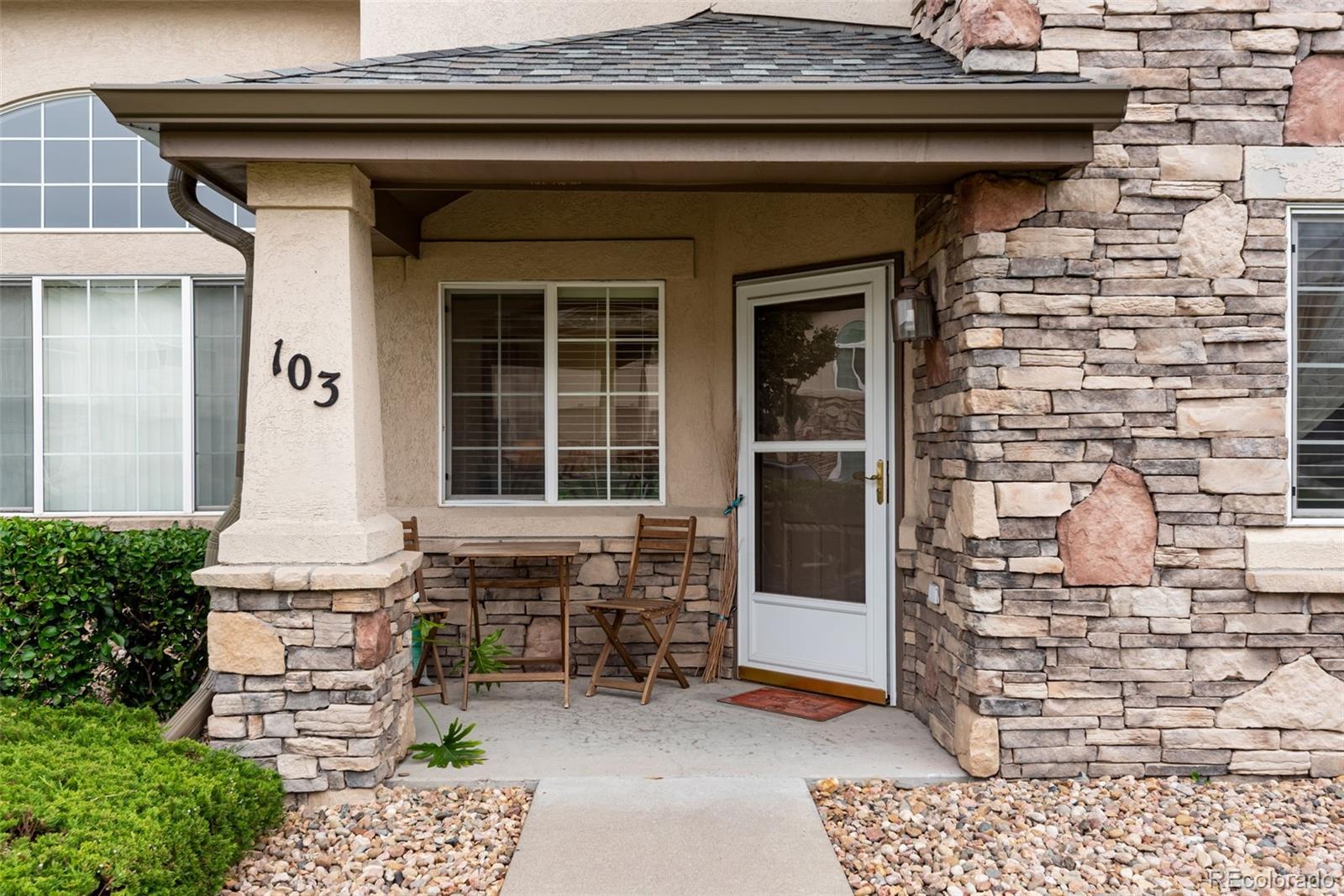 1405 South Chambers Road, Unit 103 Aurora, CO 80017 - Photo 2 of 20 a front view of a house with a garden