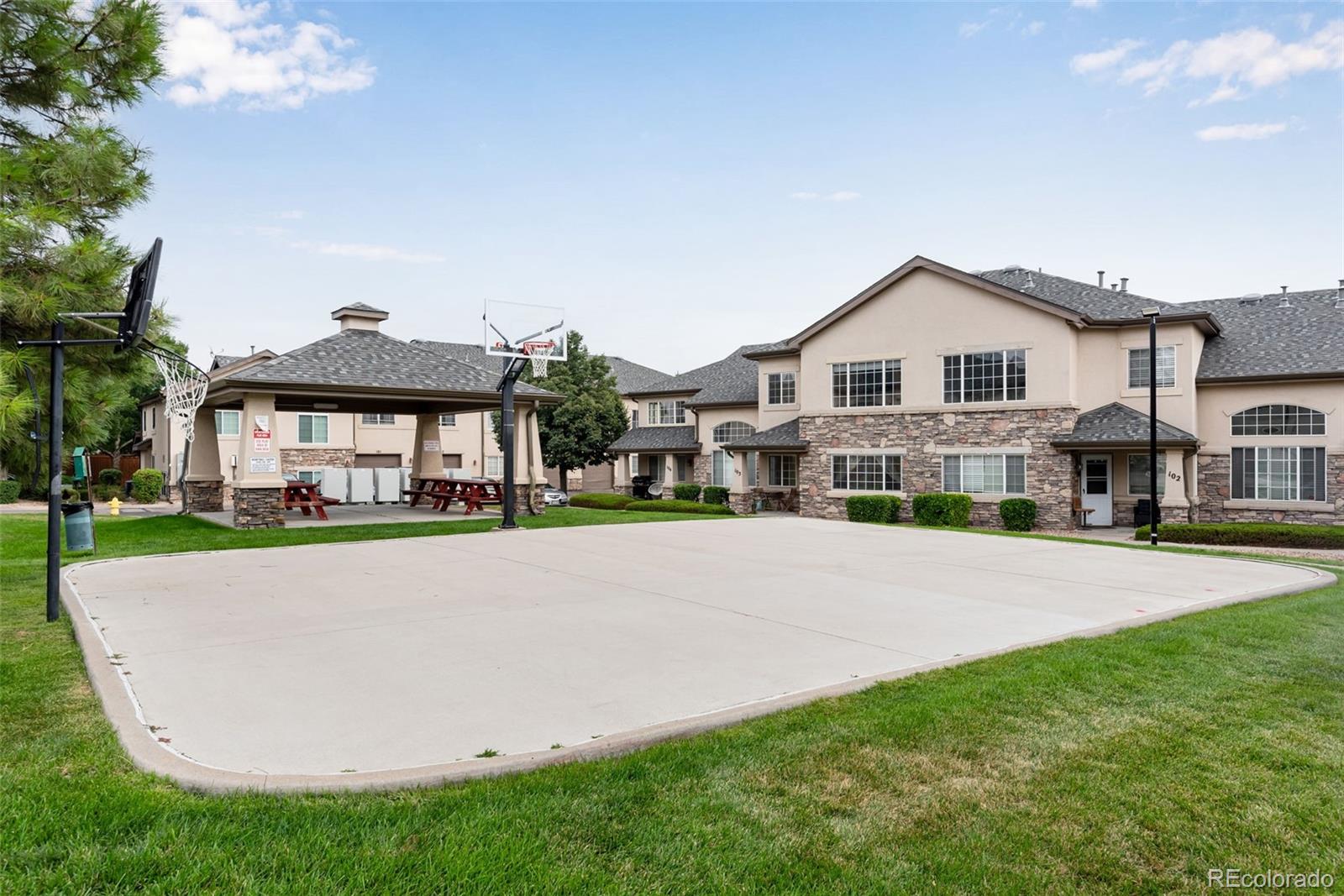 1405 South Chambers Road, Unit 103 Aurora, CO 80017 - Photo 3 of 20 a front view of a house with a garden and yard