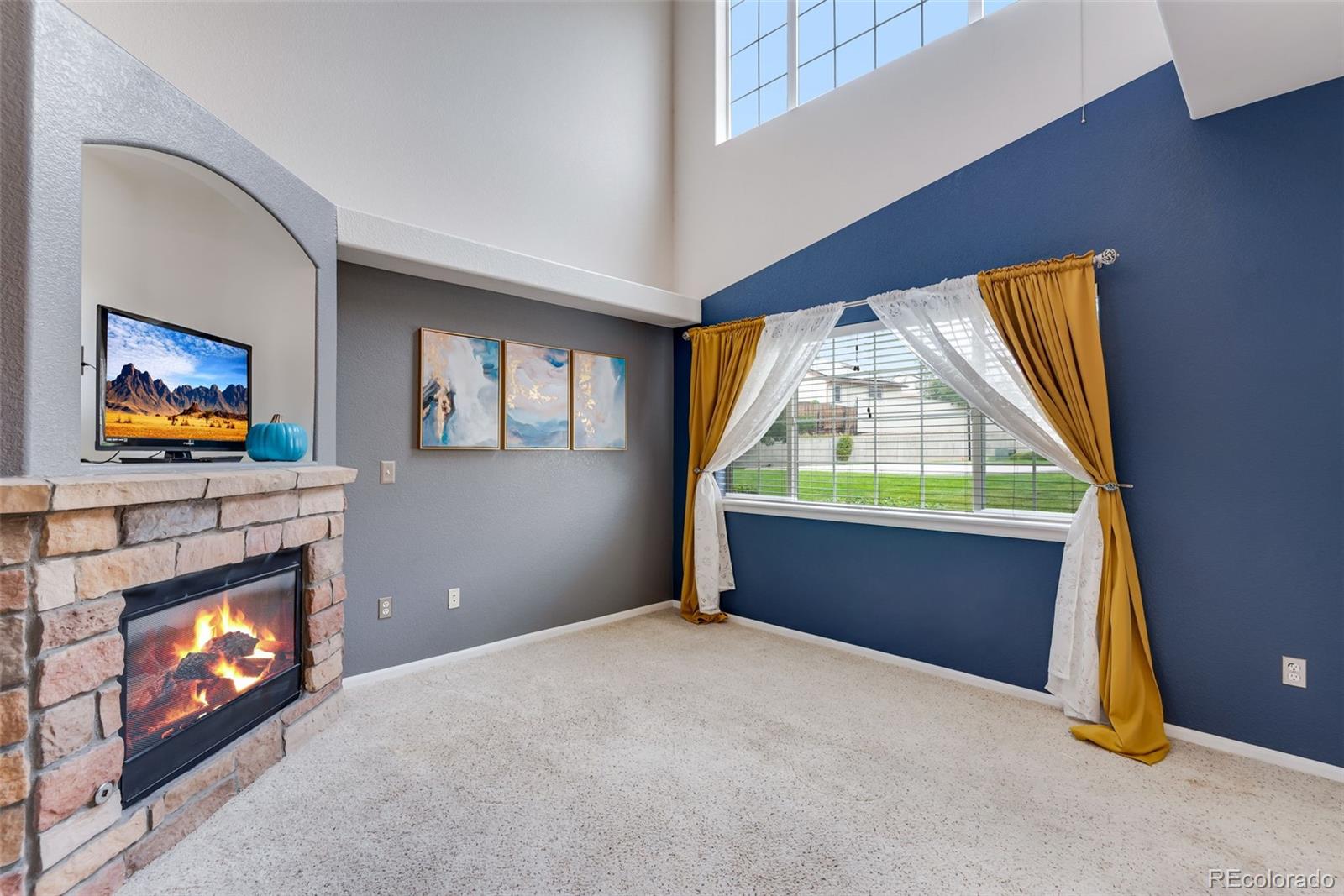 1405 South Chambers Road, Unit 103 Aurora, CO 80017 - Photo 7 of 20 a living room with window fireplace and a flat screen tv