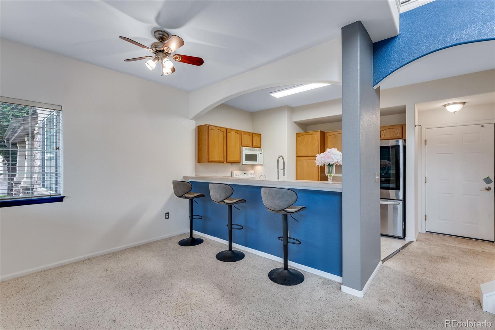 1405 South Chambers Road, Unit 103 Aurora, CO 80017 - Photo 8 of 20 a view of workspace with a chandelier fan