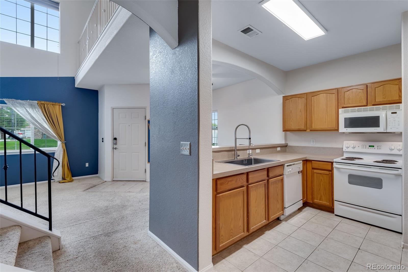 1405 South Chambers Road, Unit 103 Aurora, CO 80017 - Photo 9 of 20 a open kitchen with stainless steel appliances granite countertop a stove and a sink