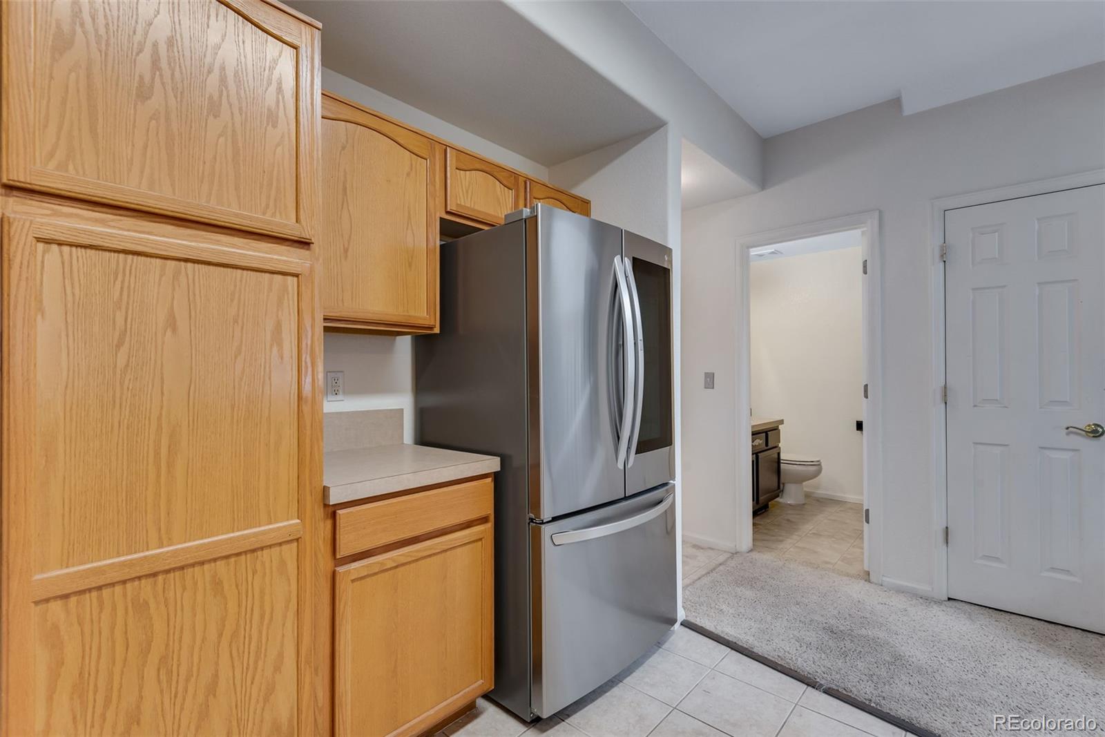 1405 South Chambers Road, Unit 103 Aurora, CO 80017 - Photo 10 of 20 a metallic refrigerator freezer sitting in a kitchen