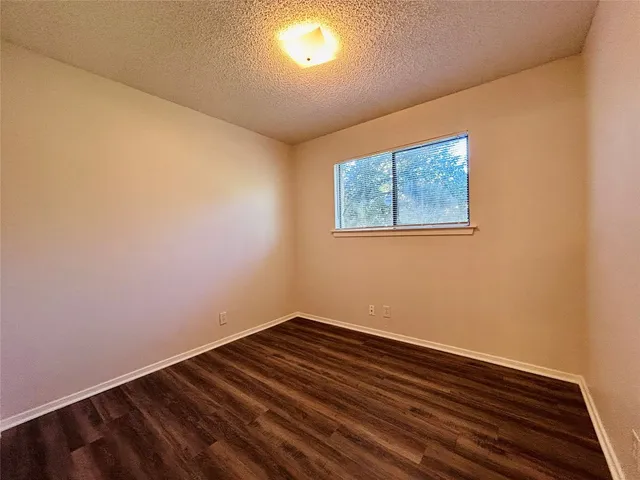 a view of room with wooden floor and fan