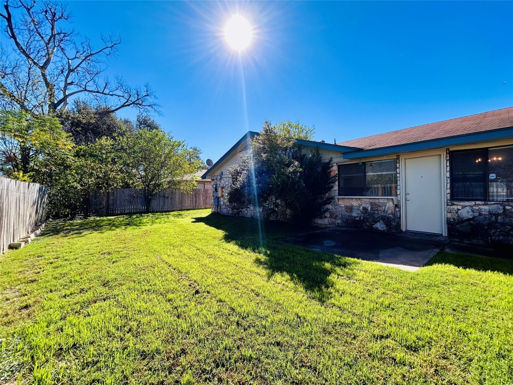 12005 Charing Cross Road, Unit A Austin, TX 78759 - Photo 17 of 19 a view of house with backyard and swimming pool