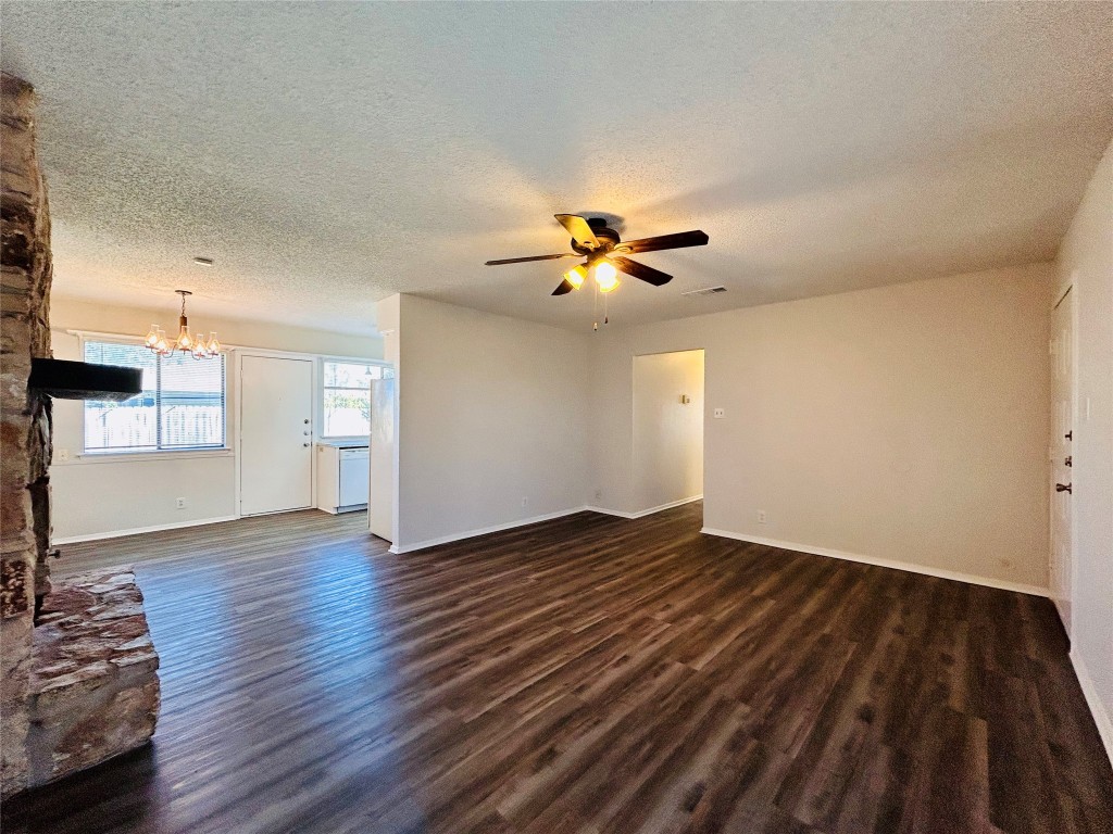 12005 Charing Cross Road, Unit A Austin, TX 78759 - Photo 4 of 19 a view of an empty room with wooden floor and a window