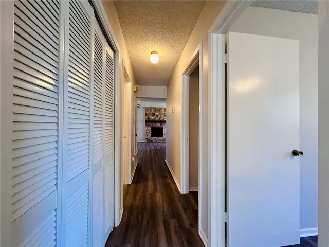 a view of hallway with wooden floor