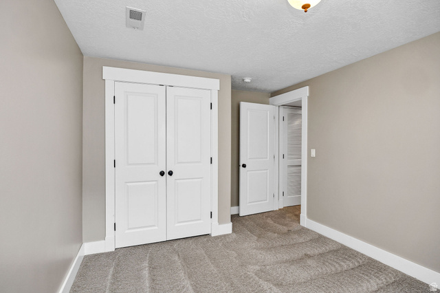 2912 South 1080th Street West Logan, UT 84321 - Photo 25 of 43 Neutral-toned interior featuring plush carpet, white baseboards, and crisp white trim around the doorways