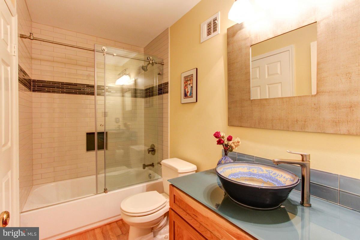 1944 Barton Hill Road Reston, VA 20191 - Photo 14 of 30 a bathroom with a granite countertop toilet sink and shower