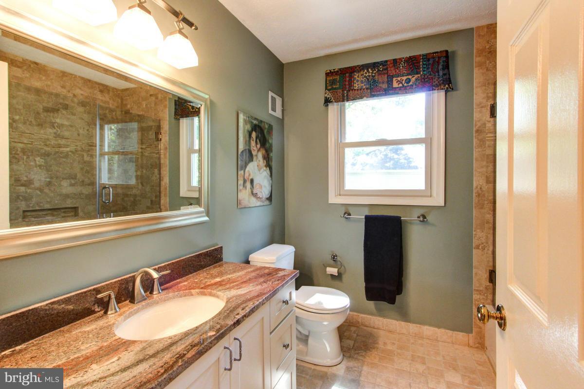 1944 Barton Hill Road Reston, VA 20191 - Photo 22 of 30 a bathroom with a granite countertop sink toilet and mirror