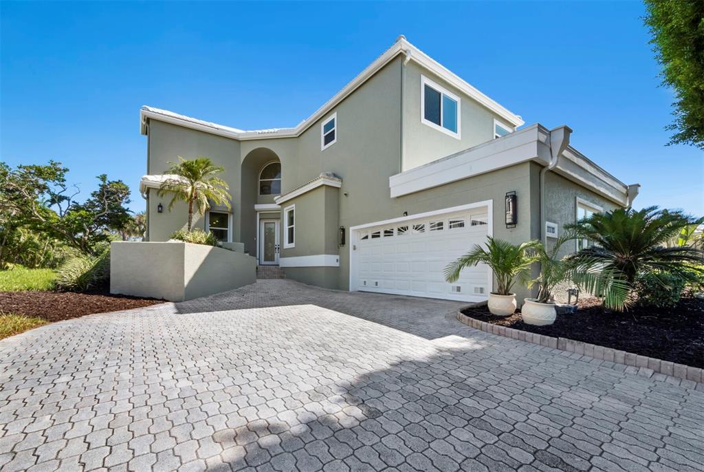 3408 Fair Oaks Lane Longboat Key, FL 34228 - Photo 1 of 76 a front view of a house with garden