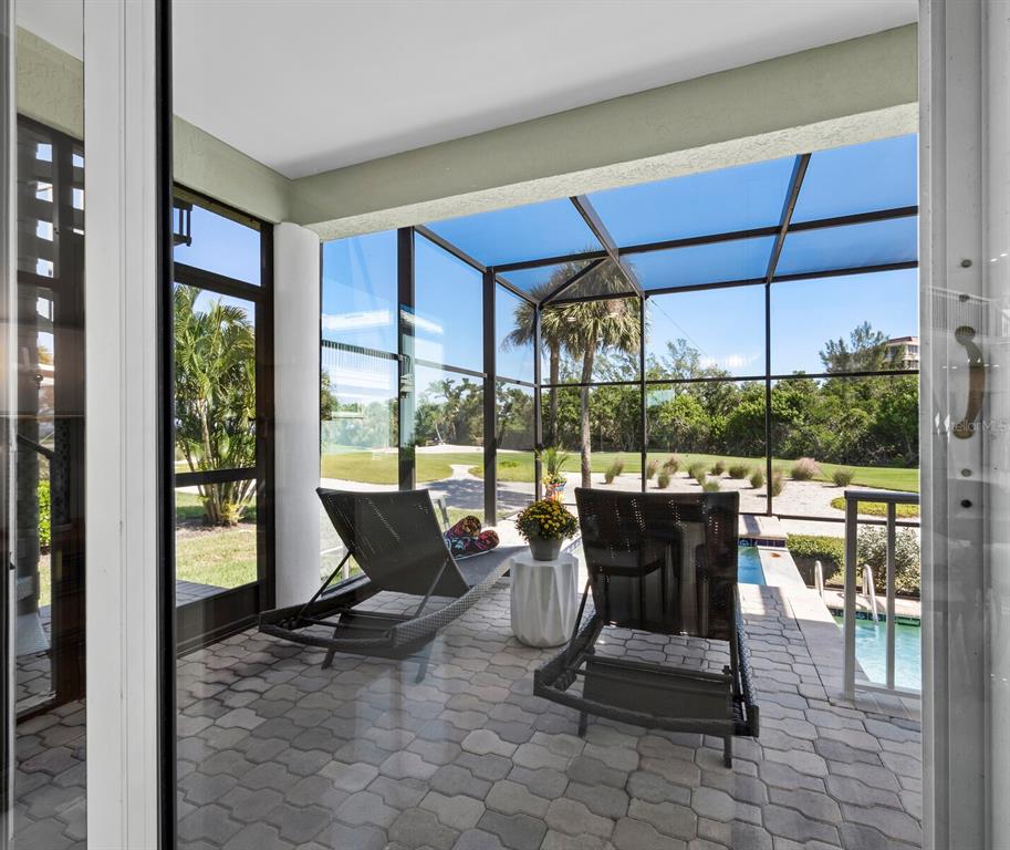 3408 Fair Oaks Lane Longboat Key, FL 34228 - Photo 14 of 76 a living room with furniture and floor to ceiling windows