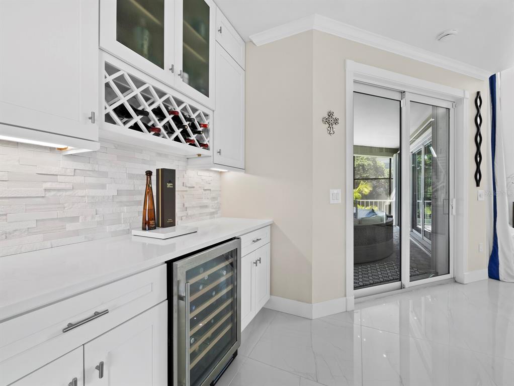 3408 Fair Oaks Lane Longboat Key, FL 34228 - Photo 15 of 76 a kitchen with a sink and a refrigerator