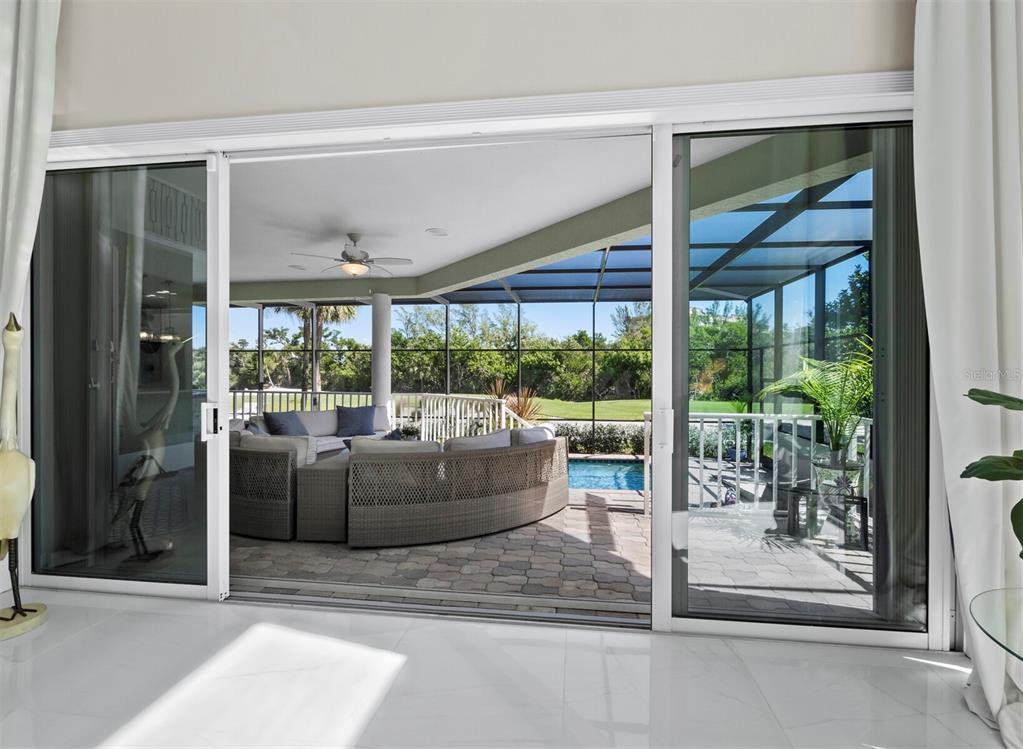 3408 Fair Oaks Lane Longboat Key, FL 34228 - Photo 16 of 76 a living room with couch and a floor to ceiling window