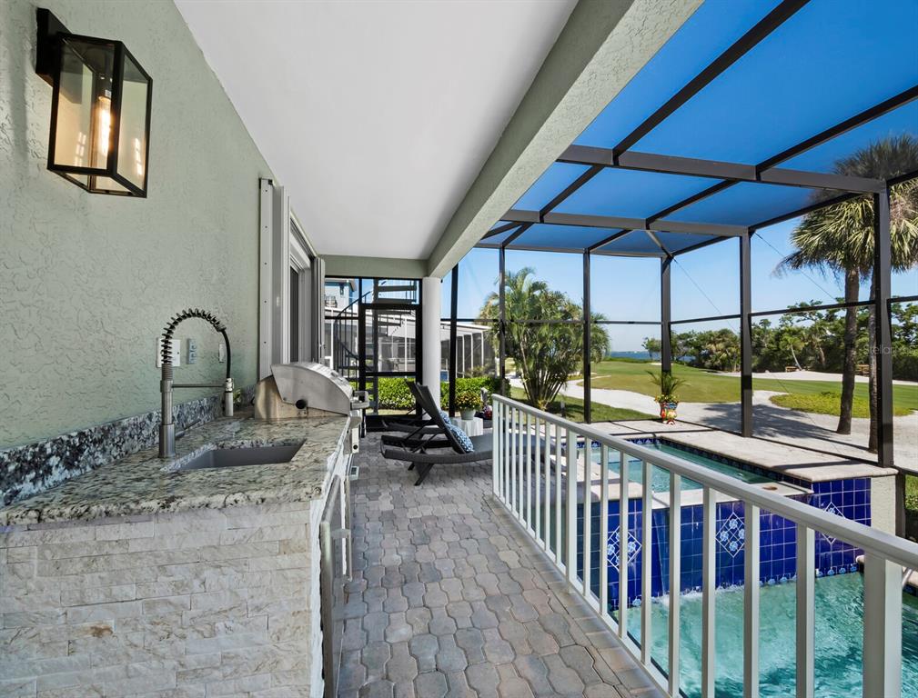 3408 Fair Oaks Lane Longboat Key, FL 34228 - Photo 18 of 76 a view of a porch with furniture and backyard