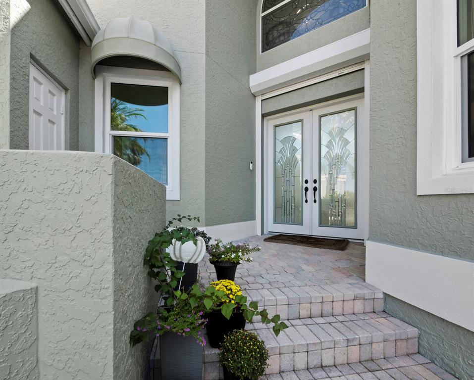 3408 Fair Oaks Lane Longboat Key, FL 34228 - Photo 2 of 76 a front view of a house with a yard