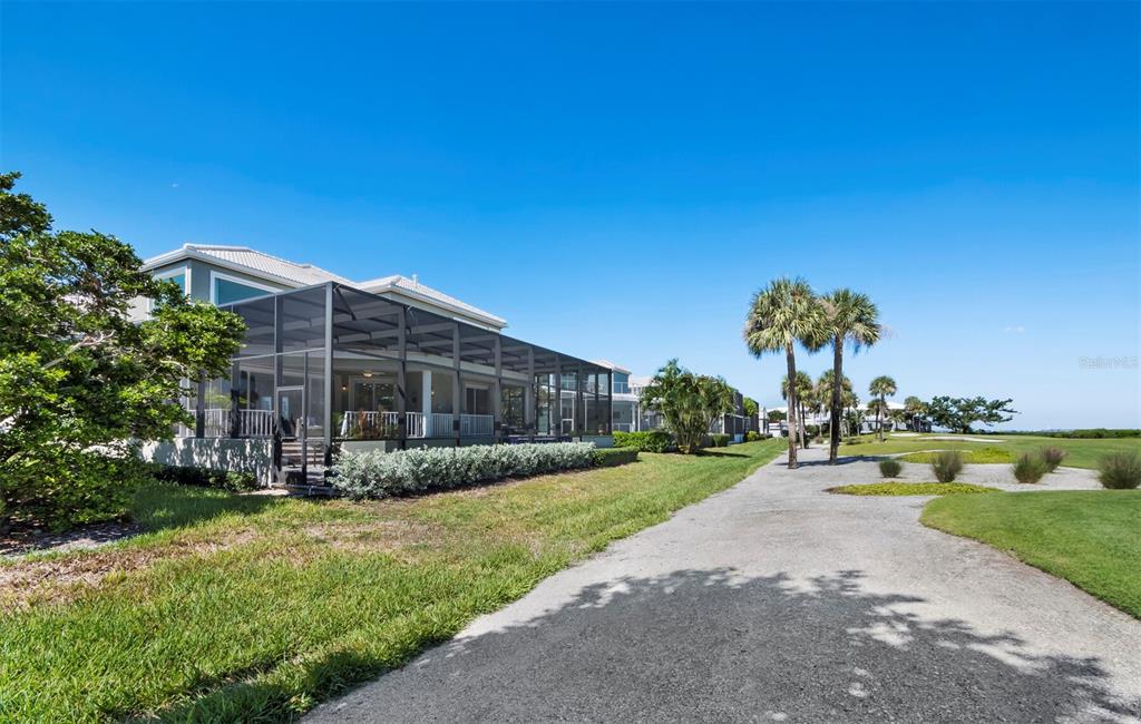 3408 Fair Oaks Lane Longboat Key, FL 34228 - Photo 23 of 76 a view of a house with a big yard and large tree