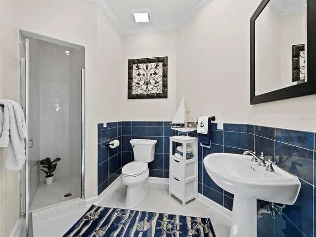a view of a livingroom with furniture hardwood floor and windows
