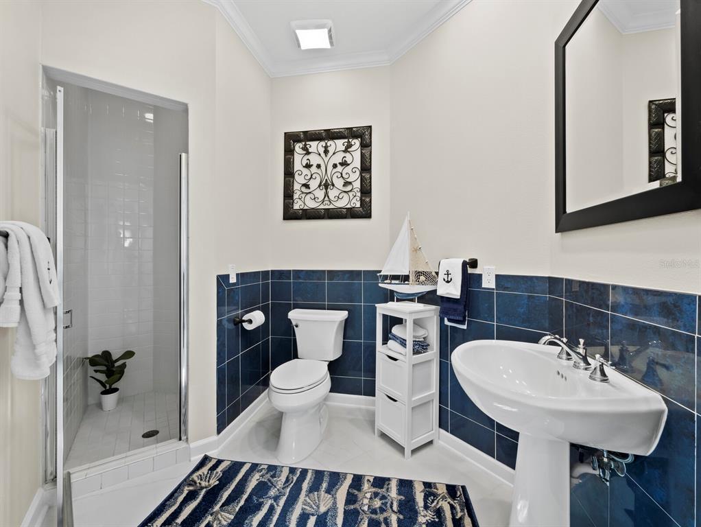 3408 Fair Oaks Lane Longboat Key, FL 34228 - Photo 24 of 76 a bathroom with a sink toilet a mirror and shower