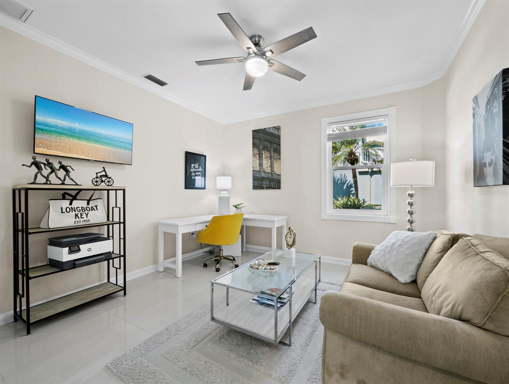 3408 Fair Oaks Lane Longboat Key, FL 34228 - Photo 25 of 76 a living room with furniture and a flat screen tv