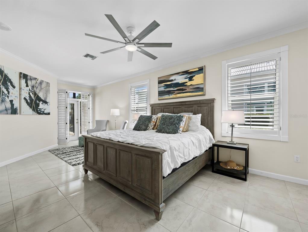 3408 Fair Oaks Lane Longboat Key, FL 34228 - Photo 26 of 76 a bedroom with a bed and a chandelier