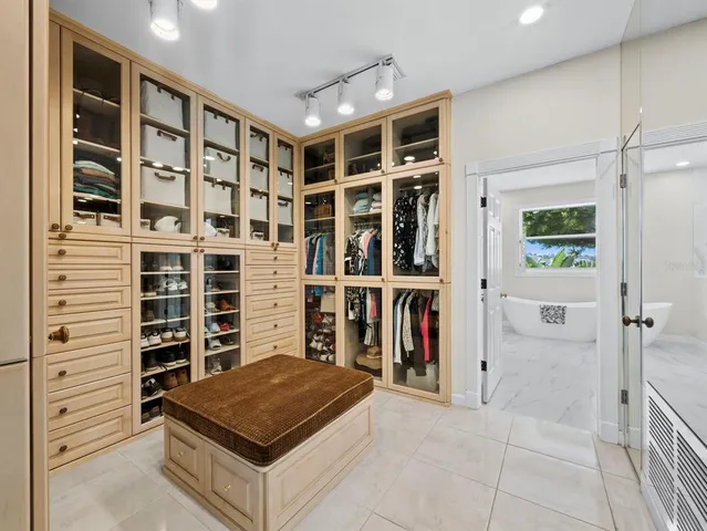 a spacious bedroom with a bed and wooden floor