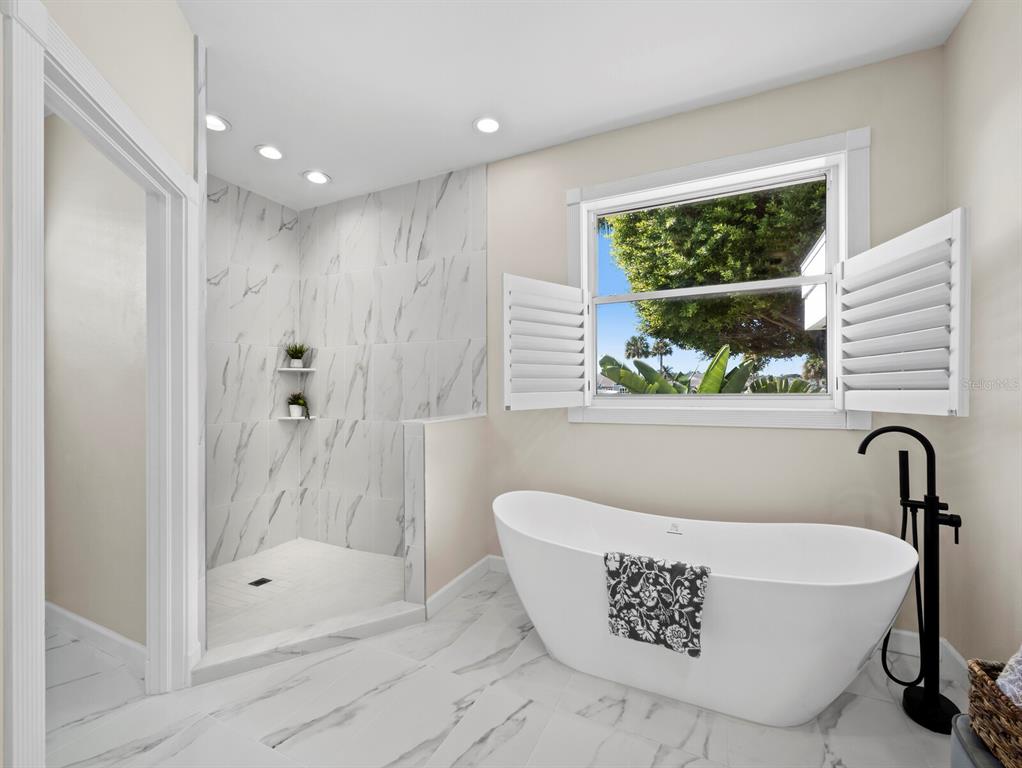 3408 Fair Oaks Lane Longboat Key, FL 34228 - Photo 31 of 76 a bathroom with a bathtub and a shower