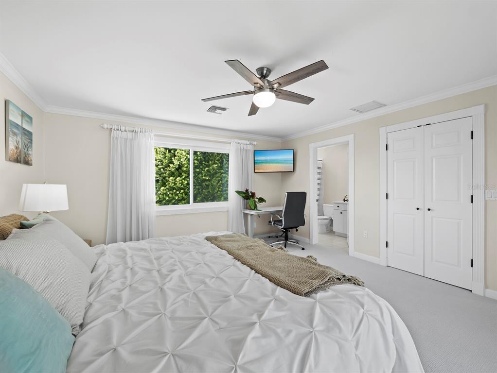 3408 Fair Oaks Lane Longboat Key, FL 34228 - Photo 35 of 76 a bedroom with a bed a chair and large window