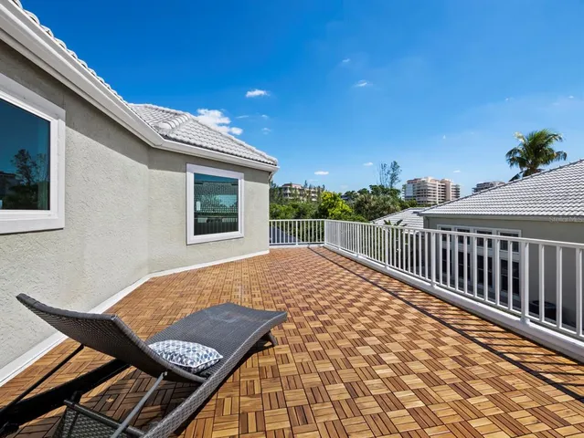 a view of balcony with furniture and wooden floor