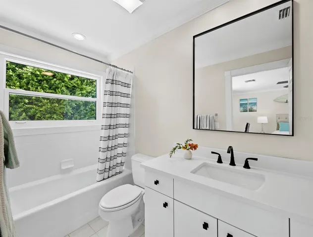 a bathroom with a glass shower door and a glass door shower