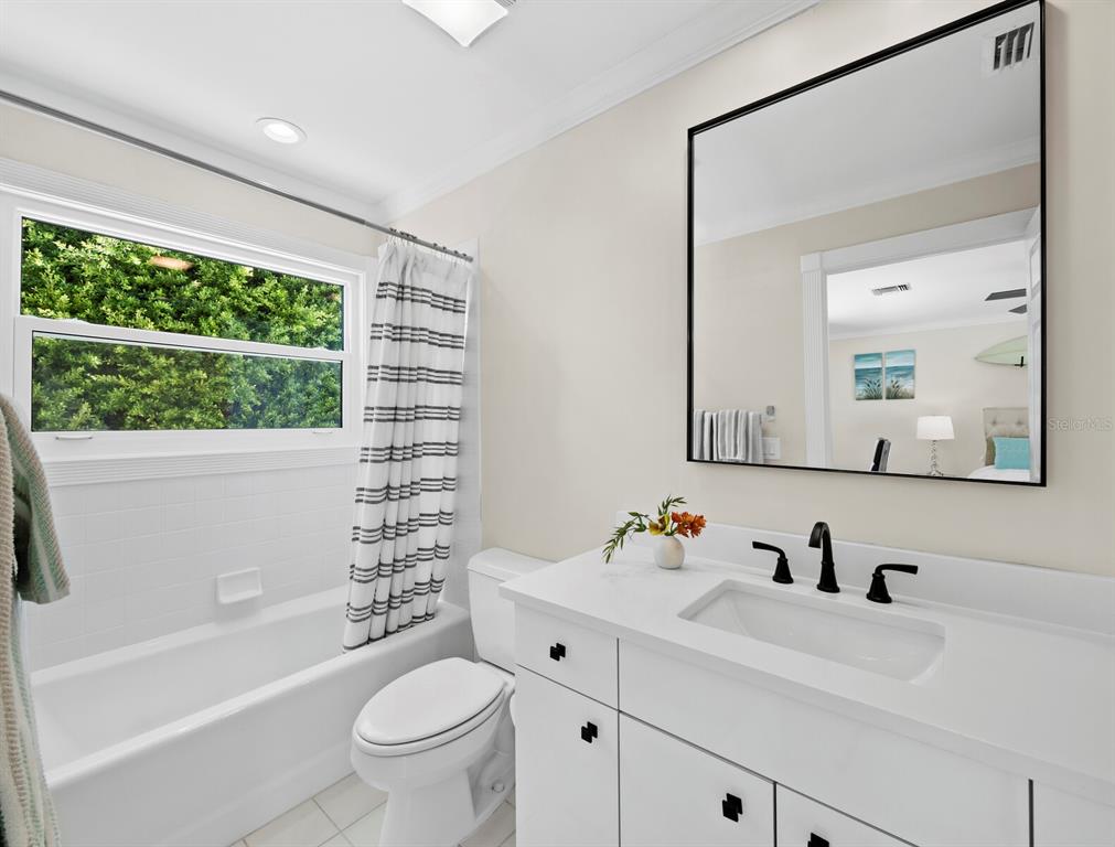 3408 Fair Oaks Lane Longboat Key, FL 34228 - Photo 37 of 76 a bathroom with a sink a toilet and a large mirror