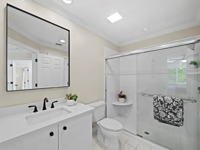 an aerial view of a house with a garden and lake view