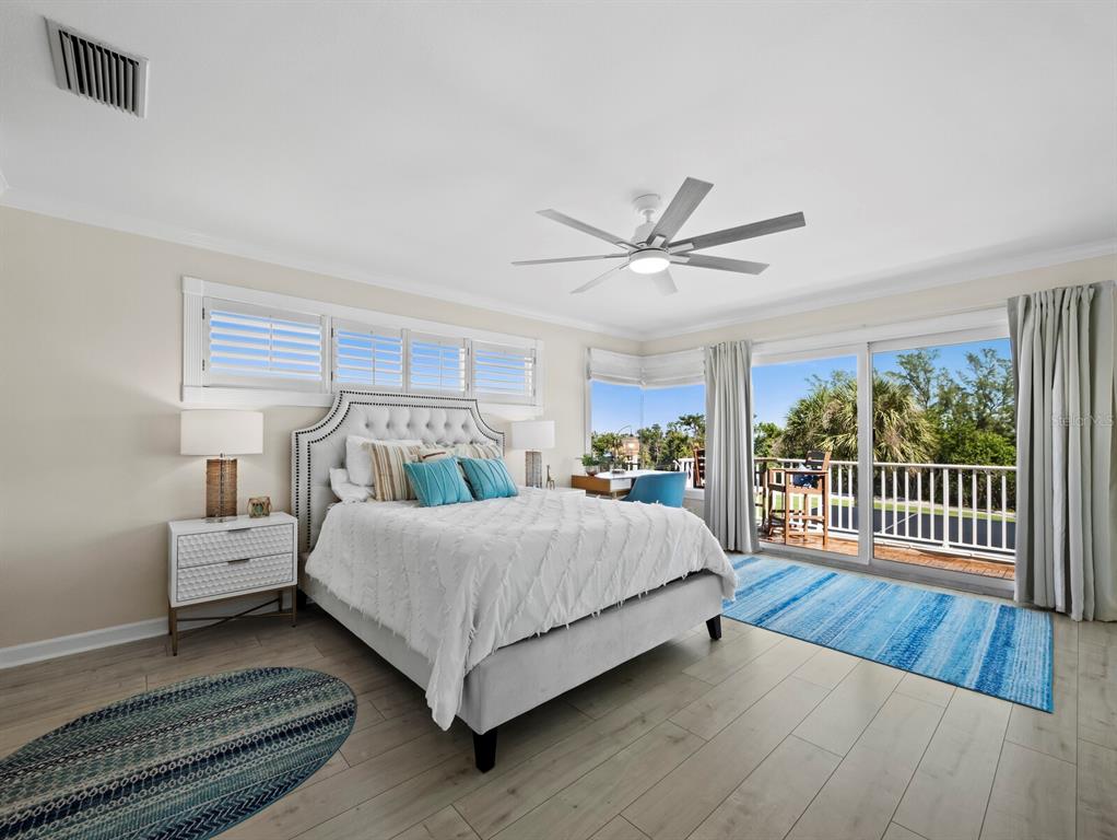 3408 Fair Oaks Lane Longboat Key, FL 34228 - Photo 41 of 76 a spacious bedroom with a bed and a large window