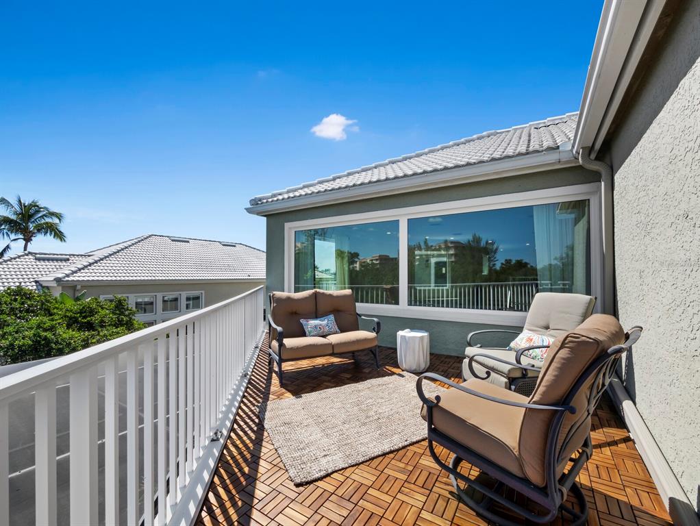 3408 Fair Oaks Lane Longboat Key, FL 34228 - Photo 47 of 76 a view of balcony with furniture and wooden floor