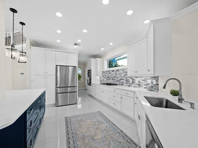 a kitchen with a sink and a refrigerator
