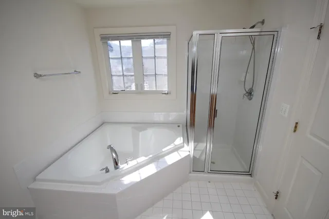 a bathroom with a tub and shower